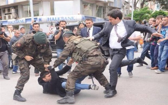 Turkish Prime Minister kicking one of the relatives of a dead miner, who was protesting