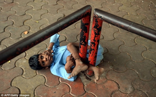 Disabled Indian boy, 9, tied by his leg to bus stop - PHOTO