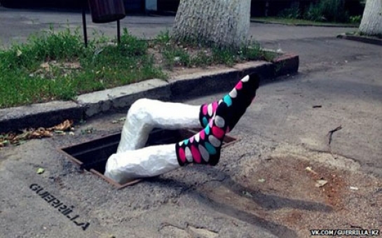 Artists come up with novel way to mark potholes