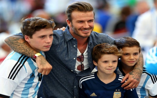 Beckham and sons showing their allegiances at the Maracana