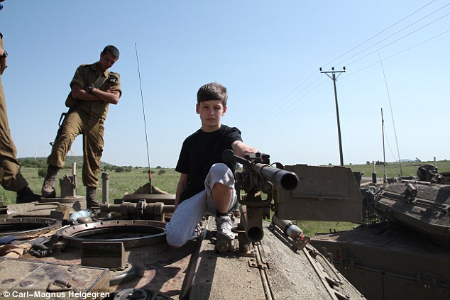 Father takes his sons to SYRIA to put them off guns - PHOTO