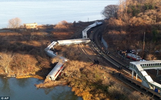 Four dead and 63 injured as all seven cars of a NYC commuter train fly off the rails