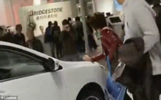 Woman scratches luxury car at motor show to force husband into buying it - VIDEO