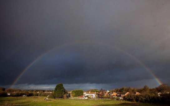 A rainbow emerges just before 80mph winds devastate Britain