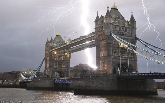 Lightning strikes over London's iconic Tower Bridge, creating an exhilarating scene - PHOTO