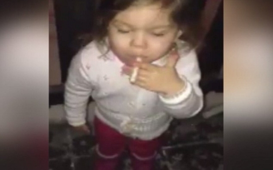 Frightening footage of toddler girl puffing on a cigarette - VIDEO