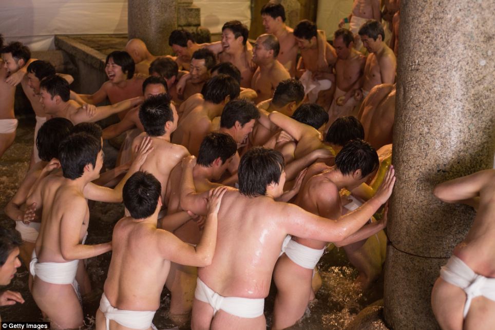 Thousands of Japanese men strip down and battle for... - PHOTO