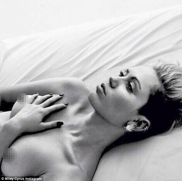 Miley Cyrus goes topless in sultry bedroom
