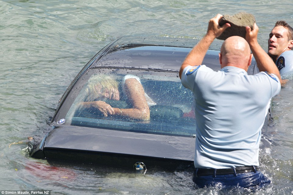 Police smashed their way into a woman's sinking BMW
