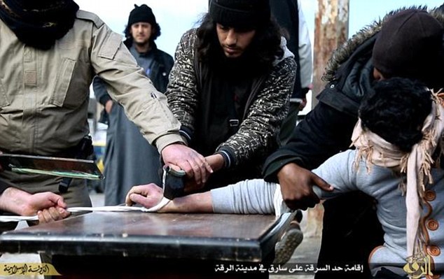 Mutilated by ISIS... terrified 'thief' has his hand hacked off
