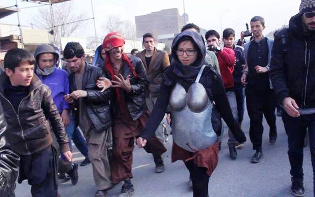 Woman in armour protesting against sexual harassment pelted with rocks