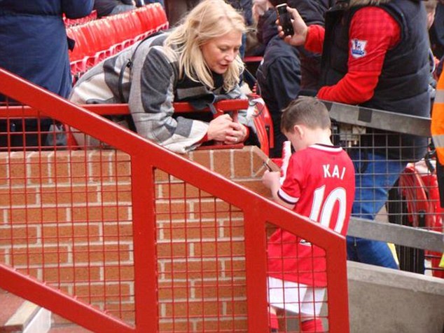 Kai Rooney, five, is asked for his AUTOGRAPH