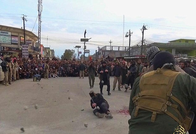 Blindfolded and bound couple being brutally stoned to death