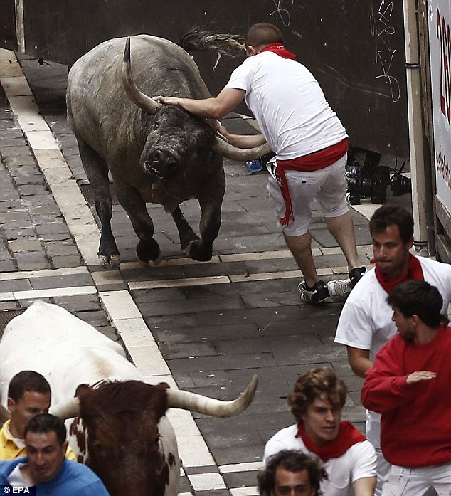 Runner is gored by a bull during the annual festival in Pamplona