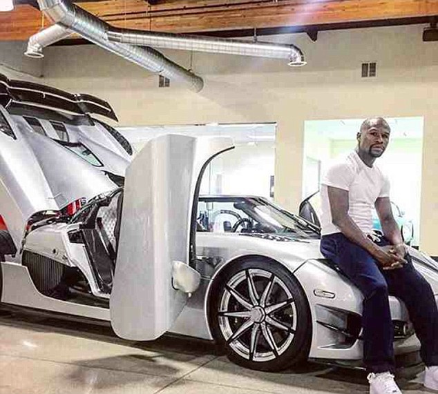 Floyd Mayweather poses for photo on top of £3m Koenigsegg supercar