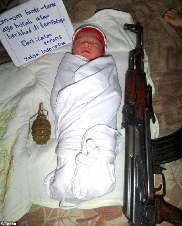 Baby jihadis: Tiny child pictured next to a gun is the face of a new wave of ISIS recruitment