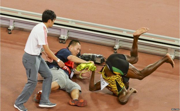 Usain Bolt knocked down in Beijing - in pictures