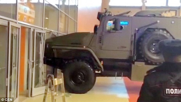 Woman attempts to drive off in an armoured personnel carrier