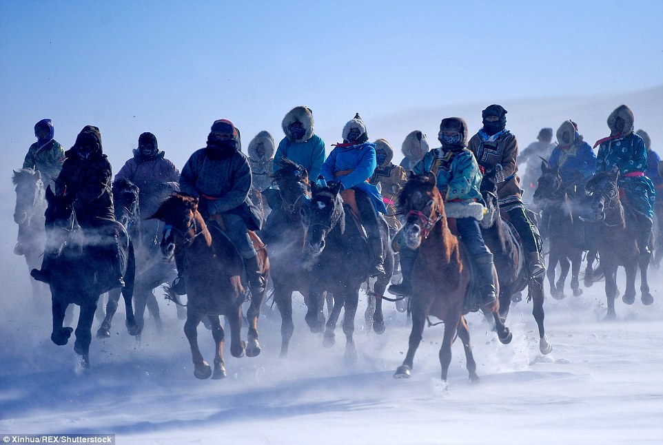 Stunning photos of Mongolian herdsmen galloping through the bitter cold on horseback