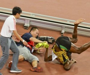 Usain Bolt knocked down in Beijing - in pictures