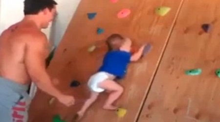 20-month-old baby scales wall at indoor gym with no ropes - VIDEO