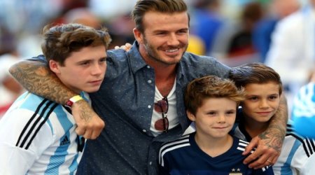 Beckham and sons showing their allegiances at the Maracana