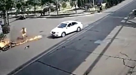 Motorbike rider is turned into human fireball after hitting car... and SURVIVES - VIDEO