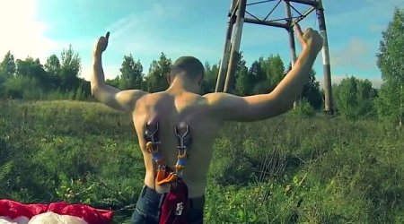 Extreme bungee jumpers attach metal hooks on harness to their skin - PHOTO