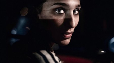 Captivating image of polar bear peeking from ice-covered sea - PHOTO