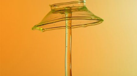 Artist drops paint onto liquid mixture and quickly captures point of impact - PHOTO