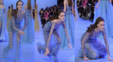 Model takes a tumble as she sashays down the catwalk - VIDEO