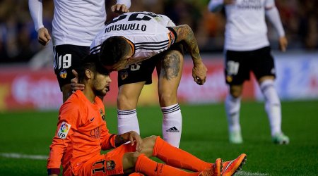 Lionel Messi is hit by a bottle after Sergio Busquets