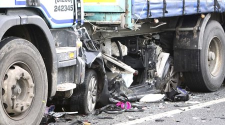 VW Golf completely crushed under articulated lorry