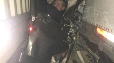 Pictured in mangled wreckage that saved his life