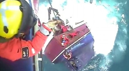 Dramatic footage shows moment fishermen cling