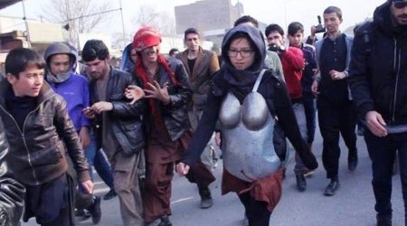 Woman in armour protesting against sexual harassment pelted with rocks