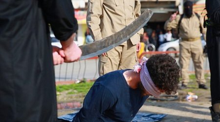 Three men are beheaded with blood-covered sword by ISIS