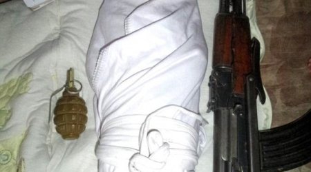 Baby jihadis: Tiny child pictured next to a gun is the face of a new wave of ISIS recruitment