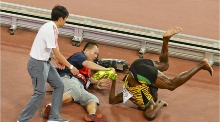 Usain Bolt knocked down in Beijing - in pictures