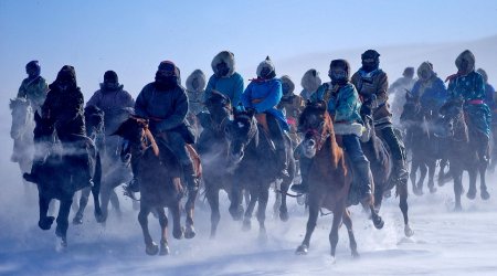 Stunning photos of Mongolian herdsmen galloping through the bitter cold on horseback