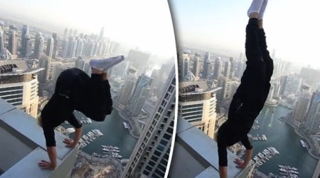 Man risks death performing handstand on skyscraper roof ledge