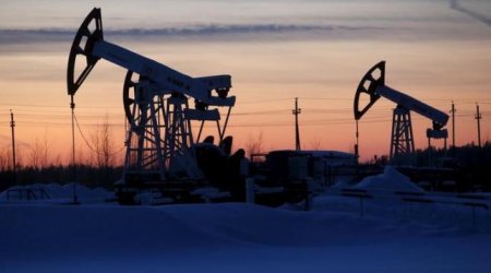 Oil jumps as sentiment gets boost, but analysts warn of ongoing glut