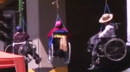 Wheelchair users dangle from bridge in extreme anti government protest