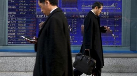 Asian shares slide, frazzled by Fed, falling oil prices
