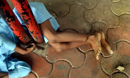 Disabled Indian boy, 9, tied by his leg to bus stop - PHOTO