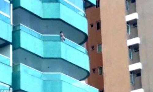 Toddler clambered out over fifth floor balcony - VIDEO