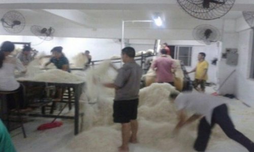 Factory causes a stink after staff pictured sticking their FEET into giant piles of noodles - PHOTO