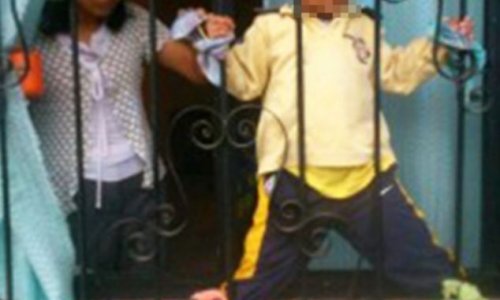 Mother chains her four-year-old son to iron railings - PHOTO