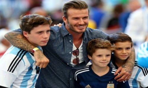 Beckham and sons showing their allegiances at the Maracana