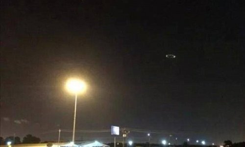 UFO photographed hovering above city's stormy skies - PHOTO+VIDEO